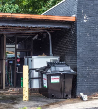 Commercial waste compactor at a business facility